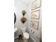 Powder room boasts pedestal sink, decorative wall art, and neutral tones at 9748 Junction Station, Fishers, IN 46037