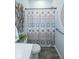 Well-lit bathroom features a decorative shower curtain, artistic wall decor, and neutral tones at 9748 Junction Station, Fishers, IN 46037