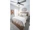 Bright bedroom featuring a ceiling fan, and decoratively textured bedding at 9748 Junction Station, Fishers, IN 46037
