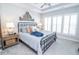 Comfortable bedroom with a king-size bed, neutral colors, and bright natural light from the shuttered windows at 9748 Junction Station, Fishers, IN 46037