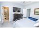Bright bedroom with a dresser, large television, walk-in shower, and grey accents at 9748 Junction Station, Fishers, IN 46037