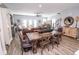 Open-concept floor plan includes dining room and living room with hardwood floors and lots of natural light at 9748 Junction Station, Fishers, IN 46037