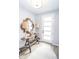 Inviting entryway features light gray walls, hardwood floors, stylish decor, and a white front door at 9748 Junction Station, Fishers, IN 46037
