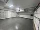 Clean, well-lit garage with epoxy flooring, offering a large area for parking and storage at 9748 Junction Station, Fishers, IN 46037