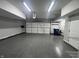 Spacious garage featuring a speckled epoxy floor, bright lighting, and ample storage solutions at 9748 Junction Station, Fishers, IN 46037
