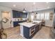 Open-concept kitchen boasts a large island, stainless steel appliances, and plenty of cabinet space at 9748 Junction Station, Fishers, IN 46037