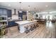 Spacious kitchen with large island, bar seating, stainless appliances, and views of the dining and living areas at 9748 Junction Station, Fishers, IN 46037