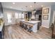Stylish kitchen features an expansive island with seating, stainless steel appliances, and abundant natural light at 9748 Junction Station, Fishers, IN 46037