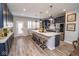 Modern kitchen features a large island with seating, stainless steel appliances, and a door to the outside at 9748 Junction Station, Fishers, IN 46037