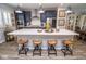Modern kitchen features a large island with seating, stainless steel appliances, and stylish pendant lighting at 9748 Junction Station, Fishers, IN 46037