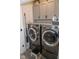Well-equipped laundry room with modern washer and dryer, overhead cabinets, and neutral tones at 9748 Junction Station, Fishers, IN 46037