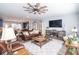Spacious living room featuring a leather sofa, large television, and an open layout to the kitchen at 9748 Junction Station, Fishers, IN 46037