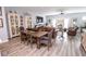 Open floor plan with dining and living space boasts hardwood floors, a large TV, and modern decor at 9748 Junction Station, Fishers, IN 46037