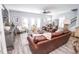 Cozy living room featuring a leather sofa, multiple chairs, hardwood flooring, and a decorative rug at 9748 Junction Station, Fishers, IN 46037