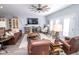Cozy living room showcases a large TV, ceiling fan, hardwood floors, and an open-concept floor plan at 9748 Junction Station, Fishers, IN 46037