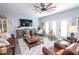 Bright living area with ceiling fan, french doors, and hardwood floors leads to a dining area and sofa at 9748 Junction Station, Fishers, IN 46037