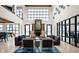 Elegant lobby with a fireplace, soaring ceilings, modern decor, and comfortable seating at 9748 Junction Station, Fishers, IN 46037