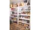 Walk-in pantry with stocked shelves and wooden accents creates an organized and charming storage space at 9748 Junction Station, Fishers, IN 46037