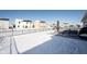 Wide backyard with fencing, patio, and lawn offering a great outdoor area covered in winter snow at 9858 Oakmont E Dr, Pendleton, IN 46064
