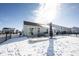Backyard with patio and black iron fence, surrounded by snowy ground and neighboring homes at 9858 Oakmont E Dr, Pendleton, IN 46064