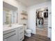 Bathroom leading into walk-in closet featuring a modern vanity and shelving at 9858 Oakmont E Dr, Pendleton, IN 46064