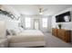 Bright bedroom with a large bed, dresser, ceiling fan, and plenty of natural light at 9858 Oakmont E Dr, Pendleton, IN 46064