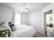Cozy bedroom featuring a comfortable bed, neutral decor, and ample natural light from the window at 9858 Oakmont E Dr, Pendleton, IN 46064