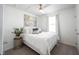 Inviting bedroom showcasing a comfortable bed with stylish pillows, a ceiling fan, and bright natural light at 9858 Oakmont E Dr, Pendleton, IN 46064