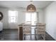 Inviting dining area with wood floors, stylish lighting, and natural light from large windows at 9858 Oakmont E Dr, Pendleton, IN 46064