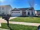 Charming one-story home with well-maintained lawn and attached two-car garage on a sunny day at 9858 Oakmont E Dr, Pendleton, IN 46064