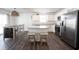 Bright, open kitchen featuring stainless steel appliances, white cabinets, and a center island with breakfast bar at 9858 Oakmont E Dr, Pendleton, IN 46064