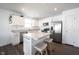 Modern kitchen boasts stainless steel appliances, white cabinetry, an island and an abundance of natural light at 9858 Oakmont E Dr, Pendleton, IN 46064