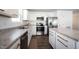 Bright kitchen with stainless steel appliances, white cabinets, granite countertops, and wood flooring at 9858 Oakmont E Dr, Pendleton, IN 46064