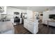 Modern kitchen featuring stainless steel appliances, white cabinets, and a granite-topped center island at 9858 Oakmont E Dr, Pendleton, IN 46064