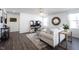Living room with hardwood floors, a comfortable sofa, and a large television at 9858 Oakmont E Dr, Pendleton, IN 46064