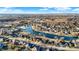 Aerial view of a beautiful waterfront community showing many homes along a winding lake and mature trees at 9970 Southwind Dr, Indianapolis, IN 46256