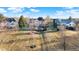 Aerial view showcases a large grassy yard with mature trees leading down to the lake at 9970 Southwind Dr, Indianapolis, IN 46256
