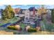 Landscaped backyard featuring a brick patio, a deck, a statue, an arbor, and mature trees at 9970 Southwind Dr, Indianapolis, IN 46256