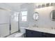 Stylish bathroom featuring a double vanity with marble countertop and decorative mirrors at 9970 Southwind Dr, Indianapolis, IN 46256