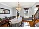 Formal dining room with hardwood floors, chandelier, and large windows offering ample natural light at 9970 Southwind Dr, Indianapolis, IN 46256