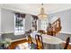 Elegant dining area featuring a chandelier and large windows, perfect for Gathering gatherings and dinner parties at 9970 Southwind Dr, Indianapolis, IN 46256