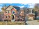 Traditional brick home with mature landscaping, two car garage, and a welcoming front porch at 9970 Southwind Dr, Indianapolis, IN 46256