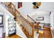 Bright foyer featuring hardwood floors, carpeted stairs, and a view into the formal dining room with chandelier at 9970 Southwind Dr, Indianapolis, IN 46256