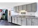 Gray cabinets and granite counters highlight this fully equipped kitchen with undermount sink and stylish backsplash at 9970 Southwind Dr, Indianapolis, IN 46256