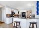 Modern kitchen with white cabinets, granite countertops, bar seating, and stainless steel appliances at 9970 Southwind Dr, Indianapolis, IN 46256