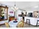 Bright breakfast nook with chandelier and views into kitchen with white cabinetry, granite countertops, and bar seating at 9970 Southwind Dr, Indianapolis, IN 46256