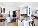 Open kitchen features granite countertops, stainless steel appliances, bar seating, and tile flooring at 9970 Southwind Dr, Indianapolis, IN 46256