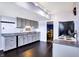A bright kitchen featuring gray cabinets, granite countertops, and hard wood floors at 9970 Southwind Dr, Indianapolis, IN 46256