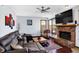 Comfortable living room features a brick fireplace, ceiling fan and plenty of natural light from windows at 9970 Southwind Dr, Indianapolis, IN 46256