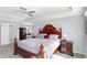 Bright main bedroom with a large window, a ceiling fan and a beautiful wood bed frame at 9970 Southwind Dr, Indianapolis, IN 46256
